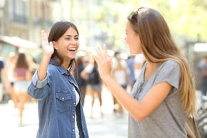 photo of two Williamsburg teenagers waving