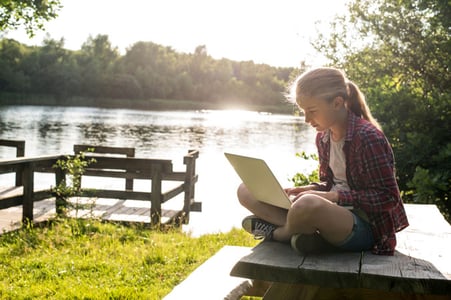 Student with working on laptop outside