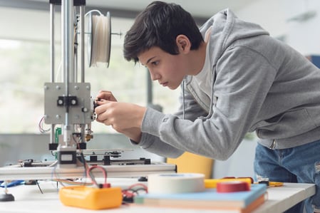 Student using a 3D printer