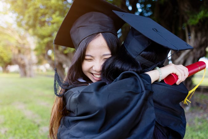 Student embracing friend at graduation