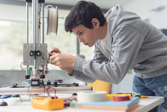 Student using a 3D printer