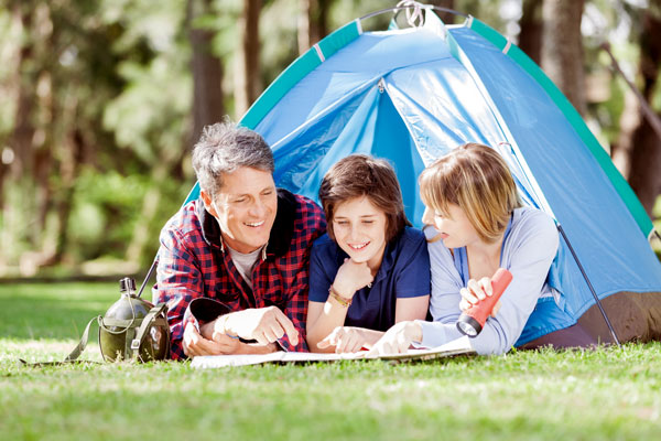 photo of family camping and doing homework - flexible classes