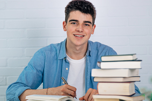 Williamsburg student with stack of books